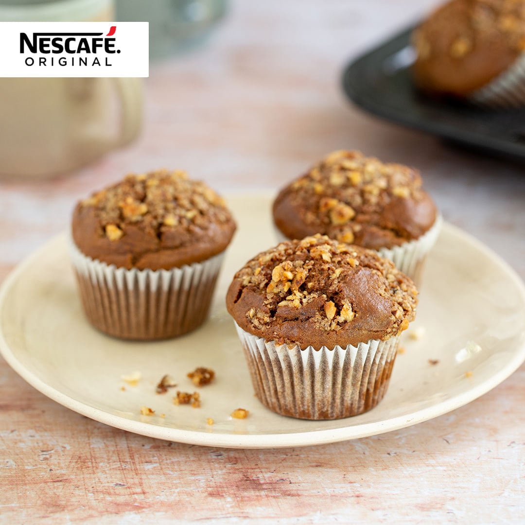 A plate of three muffins. Nescafe logo is in the top left corner.