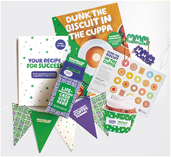Contents of the Coffee Morning Kit. Money box, cake decorations, paper bunting, stickers, recipes and more
